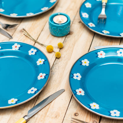 Beautiful enamel plates in teal ocean blue. Pretty, durable AND practical, they have a pretty flower design and steel rim around the edge. Camping in style! Photo shows a set of four plates.