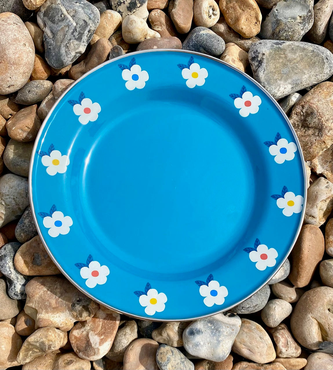 Beautiful enamel plates in teal ocean blue. Pretty, durable AND practical, they have a pretty flower design and steel rim around the edge. Camping in style!
